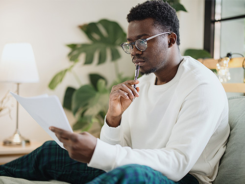 Man reading document in his home.