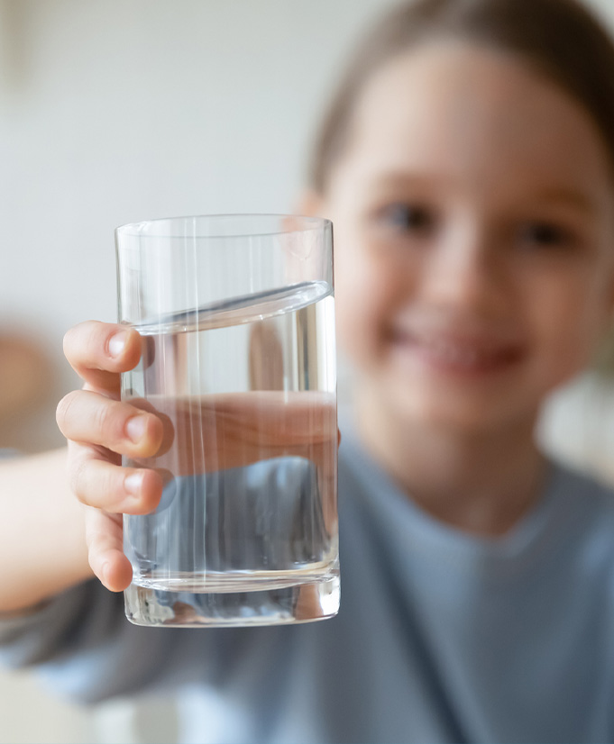 Kid holding glass of water