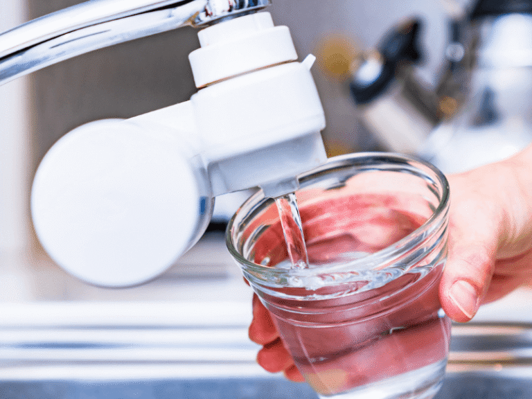 glass being filled with water from a water filter