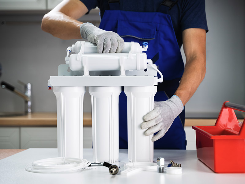 Water filtration expert putting together a new reverse osmosis unit.